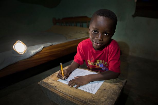 Thompson-Fianko-from-Kwame-Ghana-doing-his-homework-to-the-light-of-a-solar-bulb